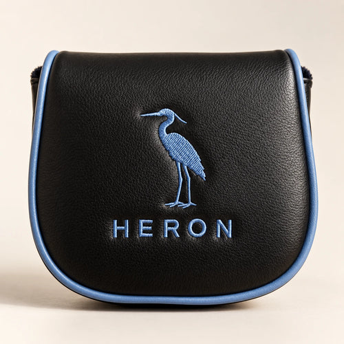 The optional embroidered leather headcover, black with the heron crest in slate blue