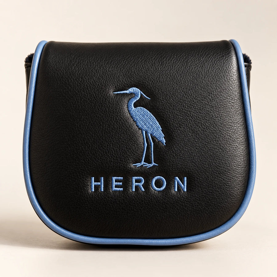 The optional embroidered leather headcover, black with the heron crest in slate blue