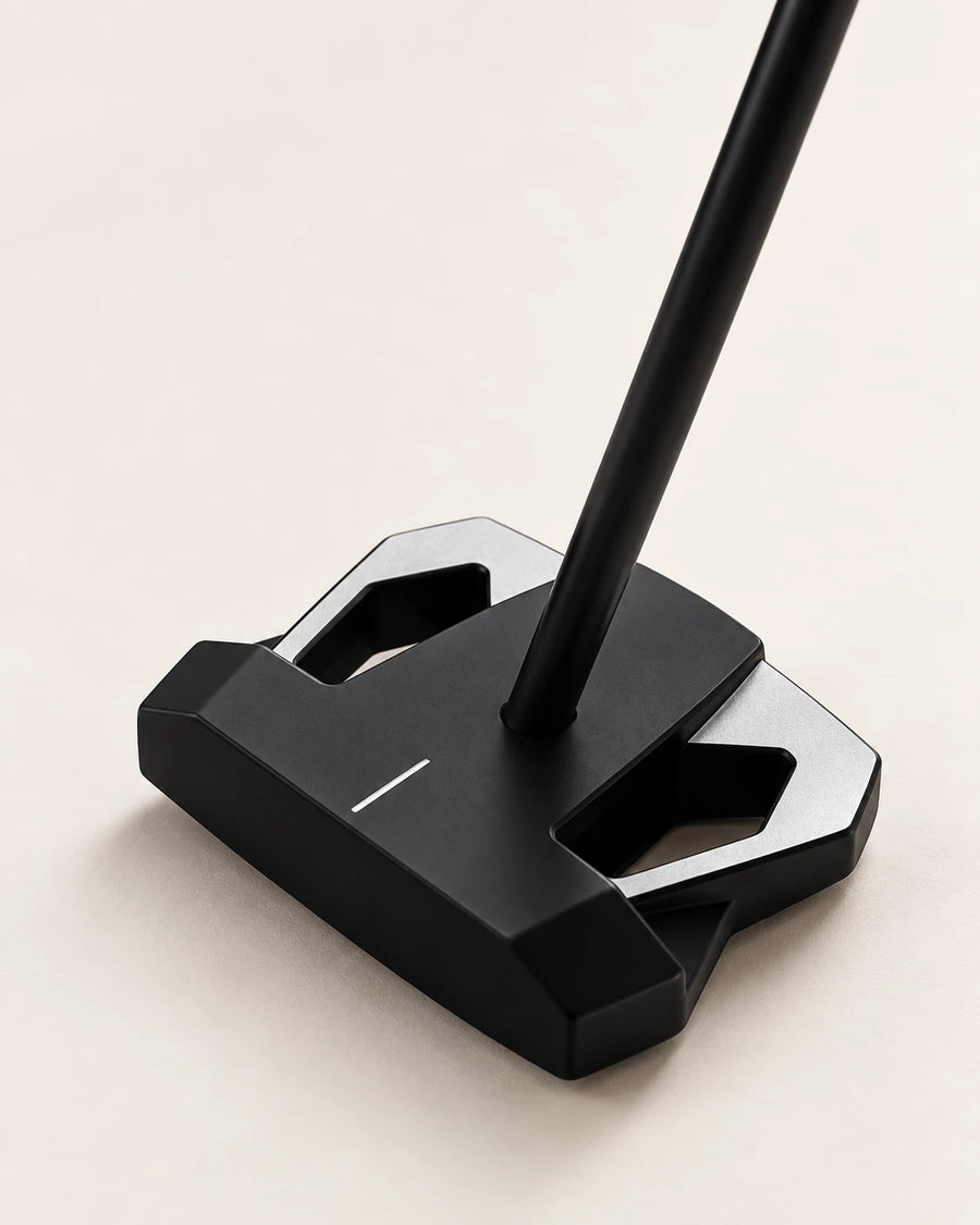 Heron 01 zero torque putter, three quarter view on a bone background